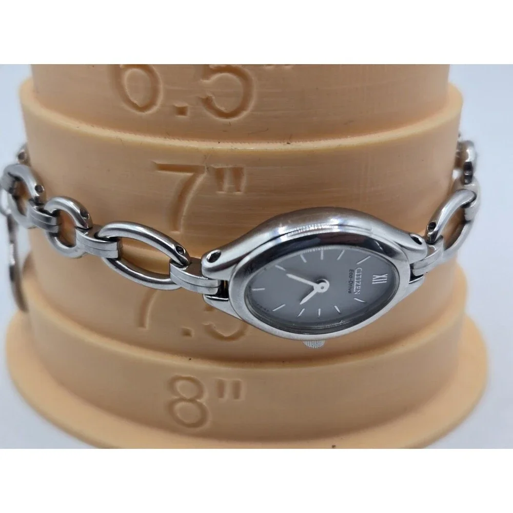 Citizen Eco-Drive Oval Silver Tone White Dial Heart Charm Bracelet Watch.